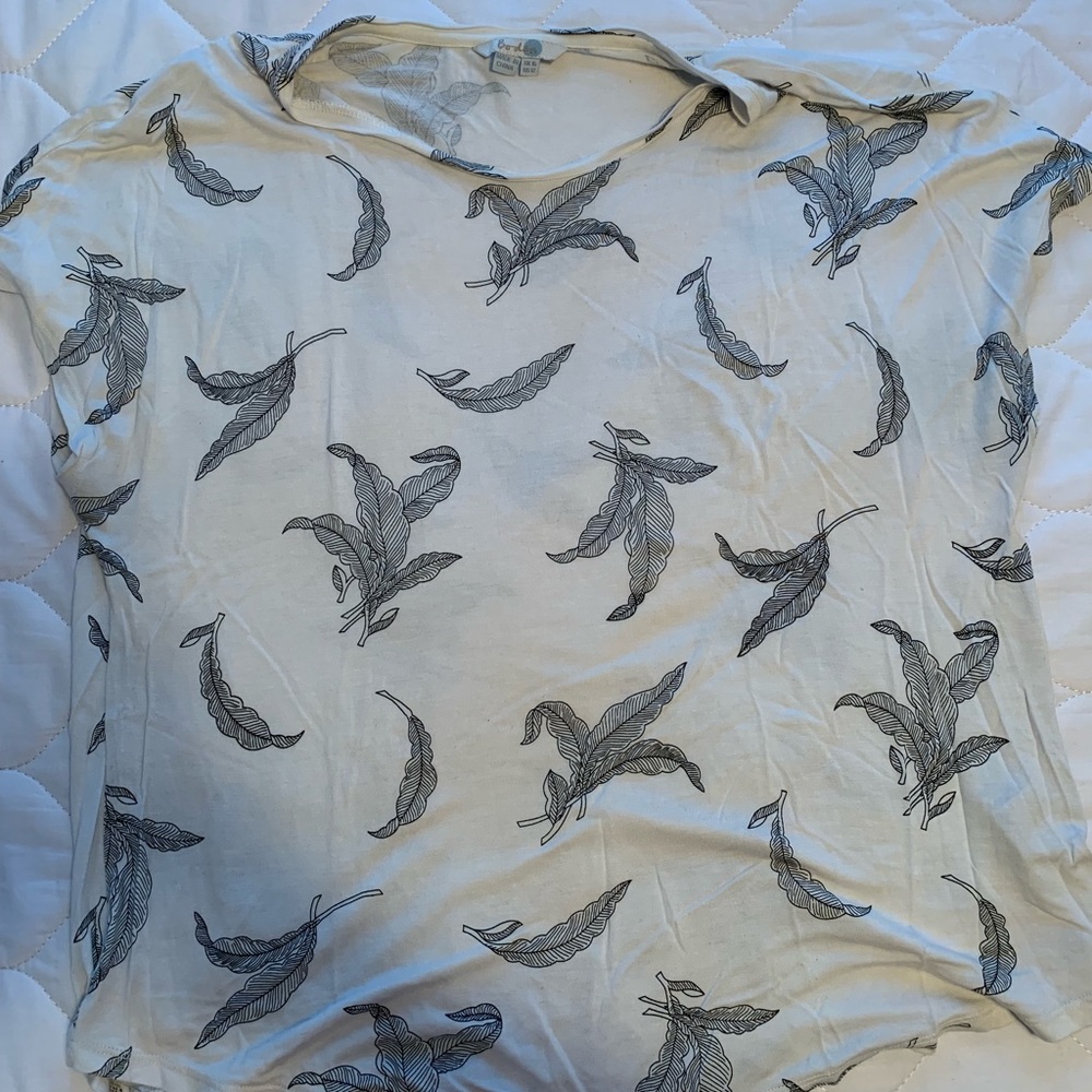 Cream colored t-shirt with black leaves